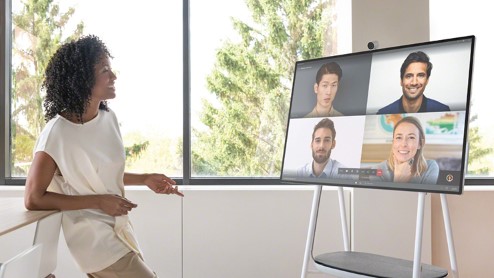 Standing in front of Surface Hub 2S during a call